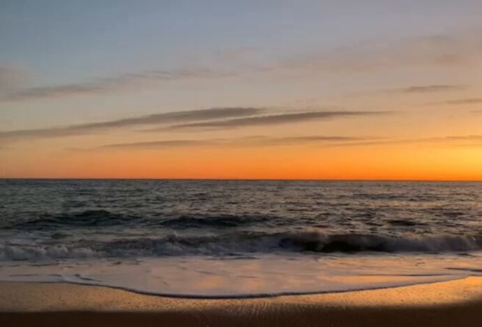 Viagens em 2021. Paisagem do areia, mar e pôr do sol.