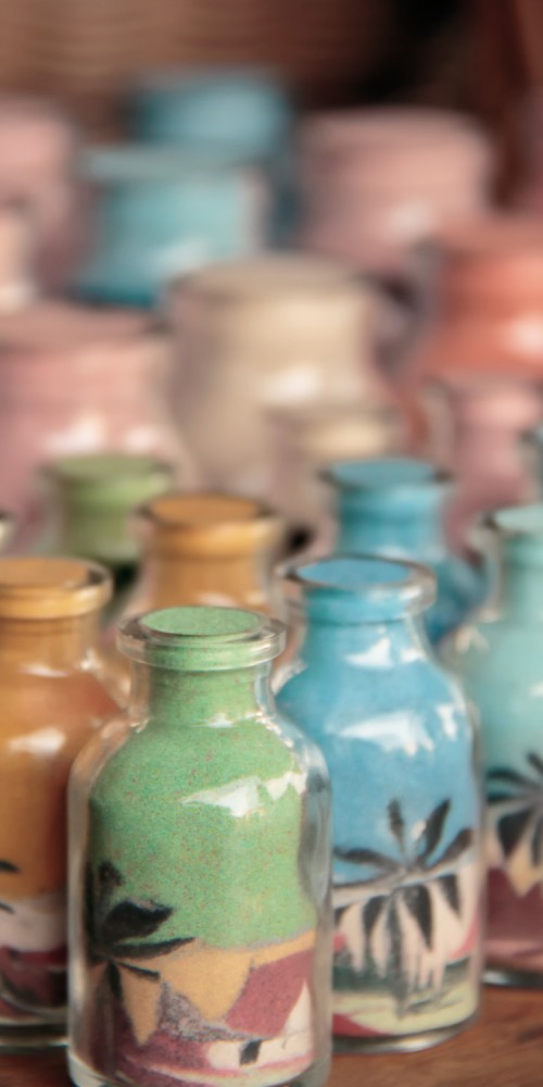 Bottles of coloured sands are a hand made craft made in the Northeast area of Brasil as a souvenir for tourists take home as decoration. This technique is also know as cycle engraving (ciclogravura).