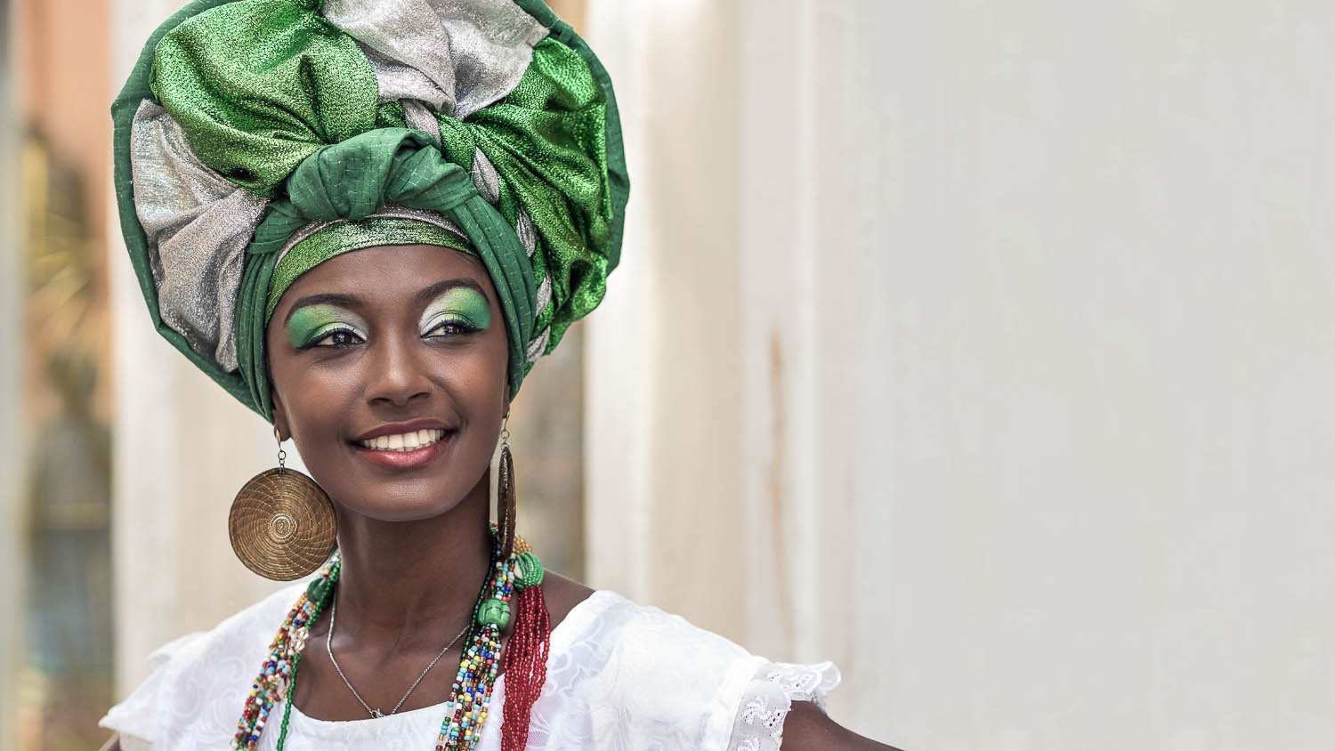 Baiana, Brazilian woman of African descent, smiling, wearing traditional attire in Pelourinho, Salvador, Bahia, Brazil.