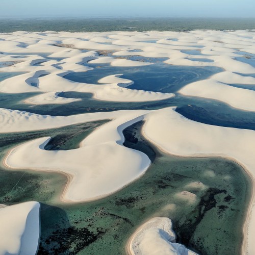 Maranhão state, Brazil – August. 21. 2010 : Aerial view of Lençóis Maranhenses National Park, located in northeastern Brazil, low, flat, occasionally flooded land, overlaid with large, discrete sand dunes with blue and green lagoons